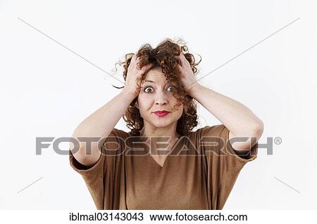 Stock Image - Young woman feeling overwhelmed. Fotosearch