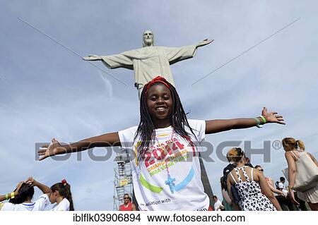"Young woman from Mozambique with her arms outstretched in front of the Christ the Redeemer statue, Cristo Redentor, on Corcovado Mountain, Rio de Janeiro, Rio de Janeiro State, Brazil, South America" View Large Photo Image Picture - "Young woman from Mozambique with her arms outstretched in front of the Christ the Redeemer statue, Cristo Redentor, on Corcovado Mountain, Rio de Janeiro, Rio de Janeiro State, Brazil, South America". Fotosearch
