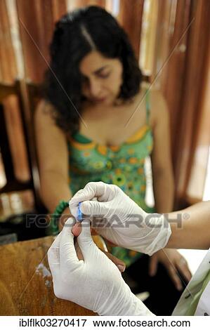 "Young woman having blood removed through a needle in her fingertip for an AIDS rapid test, Masaya, Departamento Masaya, Nicaragua, North America" View Large Photo Image Stock Photo - "Young woman having blood removed through a needle in her fingertip for an AIDS rapid test, Masaya, Departamento Masaya, Nicaragua, North America". Fotosearch