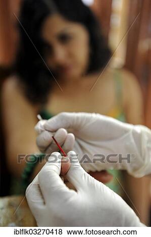 "Young woman having blood removed through a needle in her fingertip for an AIDS rapid test, Masaya, Departamento Masaya, Nicaragua, North America" View Large Photo Image Stock Photo - "Young woman having blood removed through a needle in her fingertip for an AIDS rapid test, Masaya, Departamento Masaya, Nicaragua, North America". Fotosearch