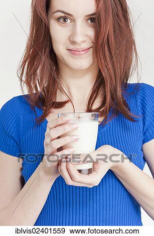 Stock Photo - Young woman holding a glass of milk. Fotosearch