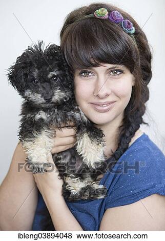 "Young woman holding a Toy Poodle, or Teacup Poodle, black and tan, Austria, Europe" View Large Photo Image Stock Photo - "Young woman holding a Toy Poodle, or Teacup Poodle, black and tan, Austria, Europe". Fotosearch