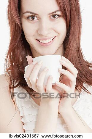Young woman holding a white cup View Large Photo Image Stock Photo - Young woman holding a white cup. Fotosearch