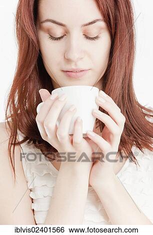 Stock Photograph - Young woman holding a white cup. Fotosearch
