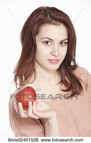 Stock Photo - Young woman holding apple. Fotosearch
