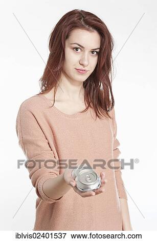 Young woman holding crushed drink cans View Large Photo Image Stock Photo - Young woman holding crushed drink cans. Fotosearch