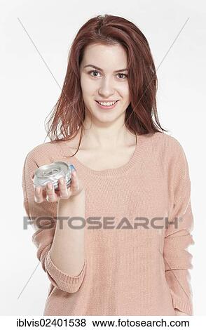 Young woman holding crushed drink cans View Large Photo Image Stock Photo - Young woman holding crushed drink cans. Fotosearch