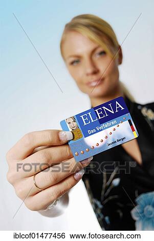 Stock Photograph - "Young woman holding the Elena jobcard, electronic proof of income". Fotosearch
