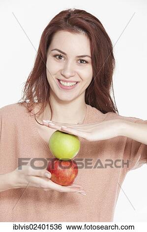 Young woman holding two apples View Large Photo Image Stock Photograph - Young woman holding two apples. Fotosearch