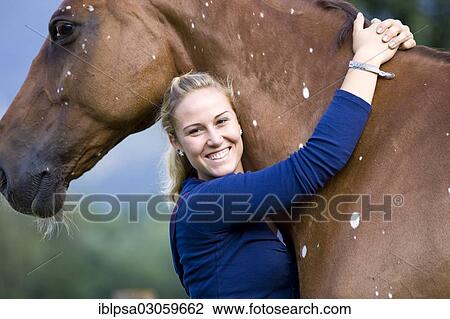 "Young woman hugging a Hanoverian, chestnut horse with white spots, pigmentation disorder, Austria, Europe" View Large Photo Image Stock Image - "Young woman hugging a Hanoverian, chestnut horse with white spots, pigmentation disorder, Austria, Europe". Fotosearch