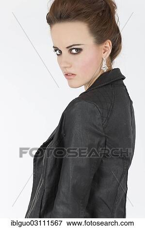 Stock Photo - Young woman in a black leather outfit. Fotosearch