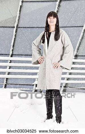 "Young woman in a coat standing in the snow, Austria, Europe" View Large Photo Image Stock Photography - "Young woman in a coat standing in the snow, Austria, Europe". Fotosearch