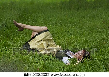 "Young woman in a dirndl with a hop crown, lying in the grass, Hop Vicequeen of Hallertau, Holledau or Hollerdau, Bavaria, Germany, Europe" View Large Photo Image Stock Image - "Young woman in a dirndl with a hop crown, lying in the grass, Hop Vicequeen of Hallertau, Holledau or Hollerdau, Bavaria, Germany, Europe". Fotosearch