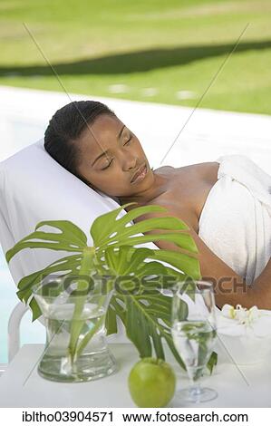 Stock Image - Young woman is enjoying a wellness and spa day. Fotosearch