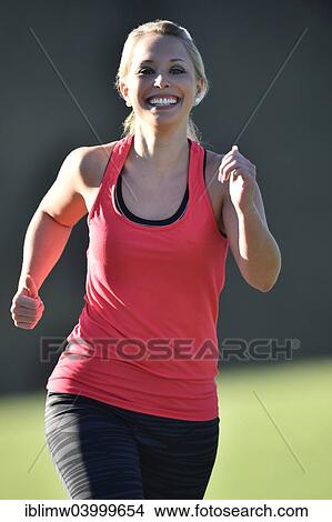 "Young woman jogging, Germany, Europe" View Large Photo Image Picture - "Young woman jogging, Germany, Europe". Fotosearch
