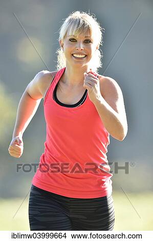 "Young woman jogging, Germany, Europe" View Large Photo Image Picture - "Young woman jogging, Germany, Europe". Fotosearch