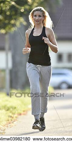 Stock Image - "Young woman jogging, Germany, Europe". Fotosearch