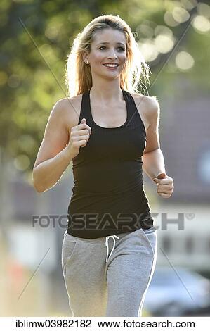 "Young woman jogging, Germany, Europe" View Large Photo Image Stock Image - "Young woman jogging, Germany, Europe". Fotosearch