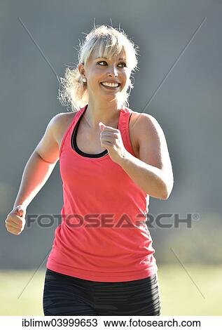 "Young woman jogging, Germany, Europe" View Large Photo Image Stock Image - "Young woman jogging, Germany, Europe". Fotosearch