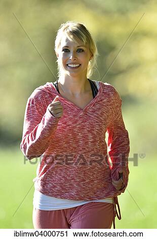 "Young woman jogging, Germany, Europe" View Large Photo Image Stock Image - "Young woman jogging, Germany, Europe". Fotosearch