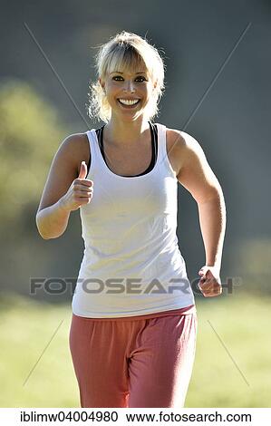 "Young woman jogging, Germany, Europe" View Large Photo Image Stock Image - "Young woman jogging, Germany, Europe". Fotosearch