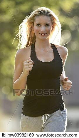 Stock Photo - "Young woman jogging, Germany, Europe". Fotosearch