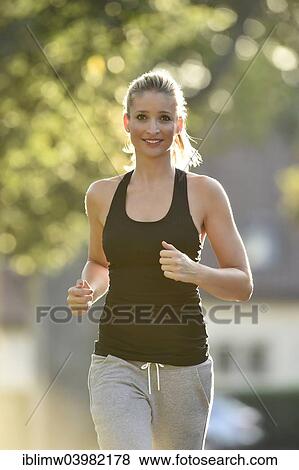 "Young woman jogging, Germany, Europe" View Large Photo Image Stock Photo - "Young woman jogging, Germany, Europe". Fotosearch