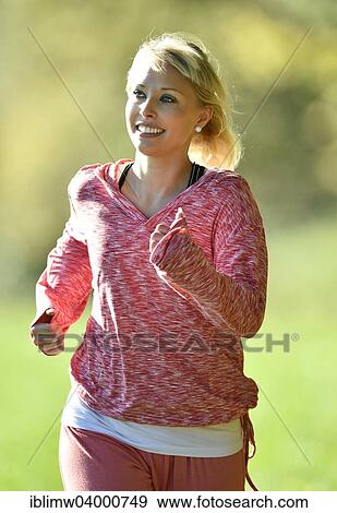 Stock Photo - "Young woman jogging, Germany, Europe". Fotosearch