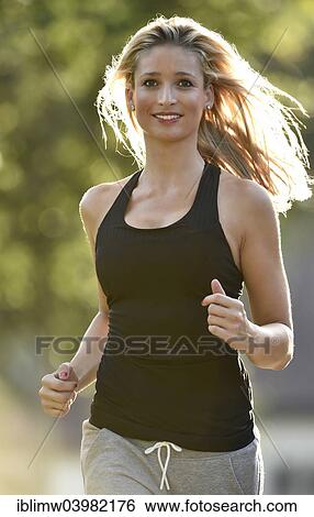 Stock Photograph - "Young woman jogging, Germany, Europe". Fotosearch