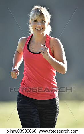 Stock Photograph - "Young woman jogging, Germany, Europe". Fotosearch