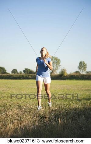 Young woman jogging outdoors View Large Photo Image Stock Image - Young woman jogging outdoors. Fotosearch