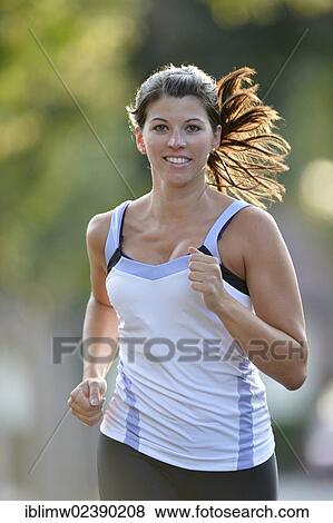 Stock Photo - "Young woman jogging, Stuttgart, Baden-Wuerttemberg, Germany, Europe, PublicGround, Europe". Fotosearch