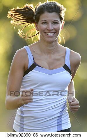 Stock Photograph - "Young woman jogging, Stuttgart, Baden-Wuerttemberg, Germany, Europe, PublicGround, Europe". Fotosearch