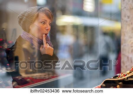 "Young woman looking in the window of a jewellery store, Grevenbroich, North Rhine-Westphalia, Germany, Europe" View Large Photo Image Stock Photograph - "Young woman looking in the window of a jewellery store, Grevenbroich, North Rhine-Westphalia, Germany, Europe". Fotosearch
