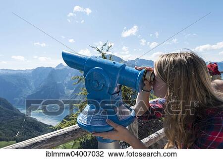 "Young woman looking through a blue telescope, on Mt Jenner, Berchtesgaden, Bavaria, Germany, Europe" View Large Photo Image Stock Image - "Young woman looking through a blue telescope, on Mt Jenner, Berchtesgaden, Bavaria, Germany, Europe". Fotosearch