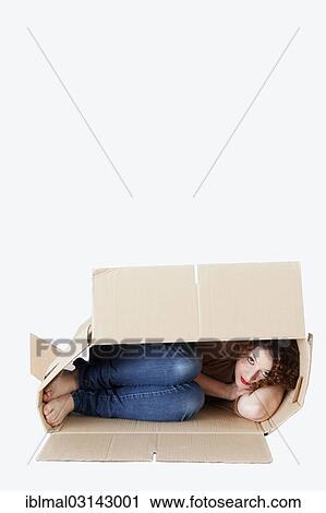 Young woman lying in a removal box View Large Photo Image Stock Image - Young woman lying in a removal box. Fotosearch