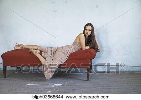 "Young woman lying on a chaise longue in a room in need of redecoration, Germany, Europe" View Large Photo Image Picture - "Young woman lying on a chaise longue in a room in need of redecoration, Germany, Europe". Fotosearch