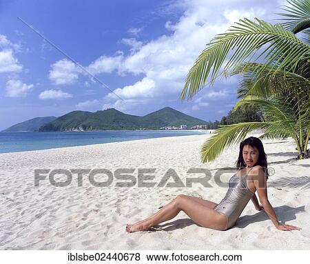 Stock Photo - "Young woman on Dadonghai Beach, white sandy beach, Sanya, Hainan Island, China, Asia". Fotosearch