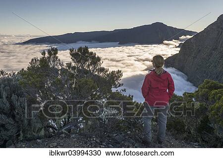 "Young woman overlooking a sea of? Çï? Çïclouds above Cilaos basin, Cirque de Cilaos, Reunion, Africa" View Large Photo Image Stock Image - "Young woman overlooking a sea of? Çï? Çïclouds above Cilaos basin, Cirque de Cilaos, Reunion, Africa". Fotosearch