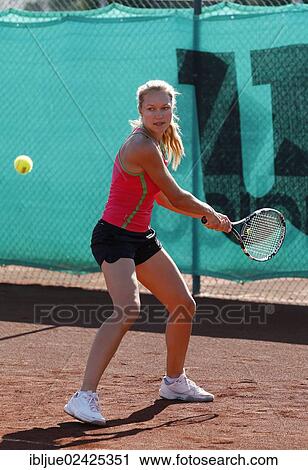 Stock Image - "Young woman playing tennis in a holiday club, Manavgat, Turkey, Asia". Fotosearch