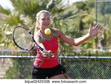 Stock Photo - "Young woman playing tennis in a holiday club, Manavgat, Turkey, Asia". Fotosearch