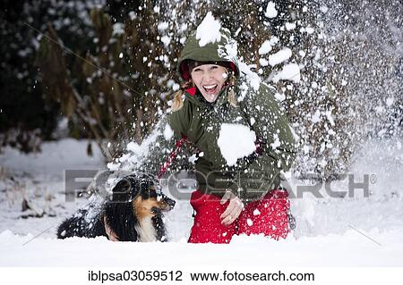 "Young woman playing with an Australian Shepherd dog in the snow, Austria, Europe" View Large Photo Image Stock Image - "Young woman playing with an Australian Shepherd dog in the snow, Austria, Europe". Fotosearch