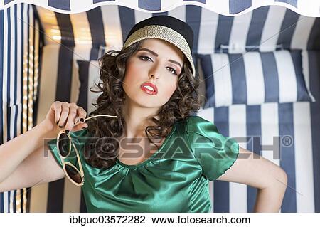 Stock Image - Young woman posing in a beach chair. Fotosearch