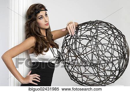 Young woman posing with a wire ball View Large Photo Image Stock Photography - Young woman posing with a wire ball. Fotosearch