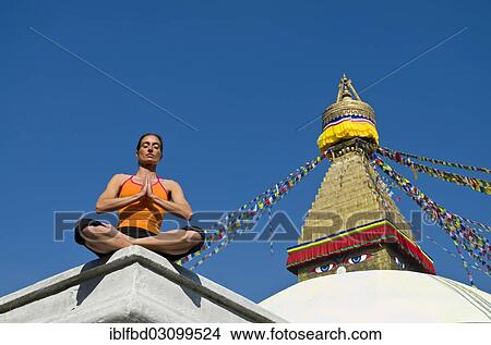 Picture - "Young woman practicing yoga at Boudnanath stupa, showing the Padmasana pose, or Lotus pose, Kathmandu Valley, Kathmandu, Kathmandu District, Bagmati Zone, Nepal, Asia". Fotosearch