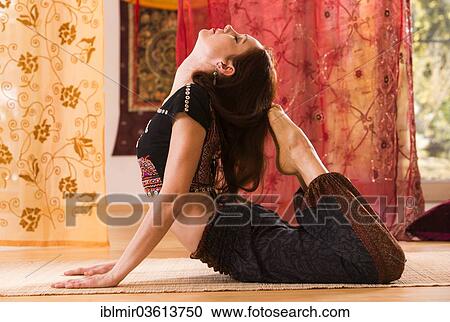 Stock Image - "Young woman practicing yoga, Germany, Europe". Fotosearch