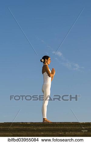 "Young woman practising Hatha yoga, outdoors, showing the pose Tadasana, Pranamasana, Prayer pose" View Large Photo Image Picture - "Young woman practising Hatha yoga, outdoors, showing the pose Tadasana, Pranamasana, Prayer pose". Fotosearch