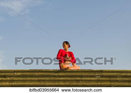 "Young woman practising Hatha yoga, outdoors, showing the pose Ardha Matsyendrasana, half spinal twist" View Large Photo Image Picture - "Young woman practising Hatha yoga, outdoors, showing the pose Ardha Matsyendrasana, half spinal twist". Fotosearch