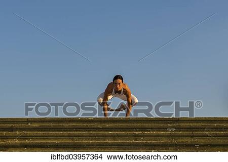 "Young woman practising Hatha yoga, outdoors, showing the pose Kakasana, Bakasana, Crow pose, Crane pose" View Large Photo Image Picture - "Young woman practising Hatha yoga, outdoors, showing the pose Kakasana, Bakasana, Crow pose, Crane pose". Fotosearch