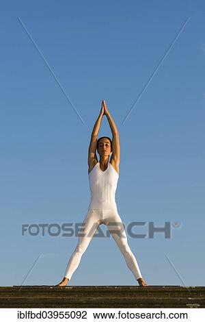 "Young woman practising Hatha yoga, outdoors, showing the pose Tadasana, Mountain pose, with legs apart" View Large Photo Image Stock Image - "Young woman practising Hatha yoga, outdoors, showing the pose Tadasana, Mountain pose, with legs apart". Fotosearch